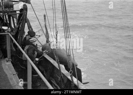 The Royal Navy during the Second World War The orepesa float on board a minesweeper being hoisted overboard. This device is used to cut the cables of submerged mines. Stock Photo