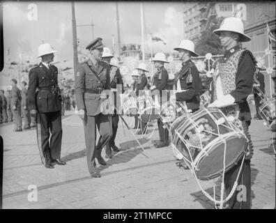 The Royal Navy in summer of 1945 Prince Bernhard of the Netherlands inspecting the Royal Marine Band (Portsmouth Division) during the opening of an Allied Naval Exhibition in Rotterdam. Note the leopard skin being warn by the drummer nearest the camera. Stock Photo