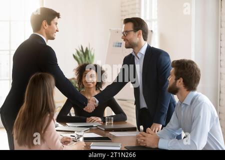 Two successful managers men in formal jackets greeting each other Stock Photo