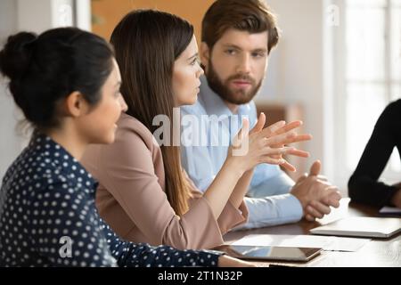 Diverse millennial startup team discussing work project Stock Photo