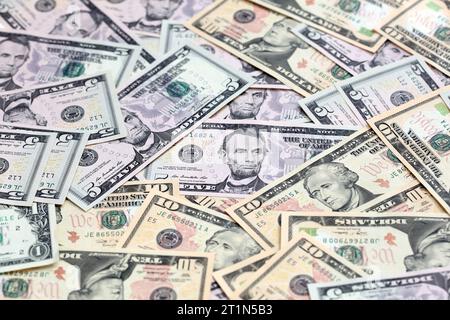 Various US dollar notes scattered. No complete notes shown and angled shot. Focus on central banknote. Stock Photo
