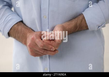 Man cracking his knuckles, closeup. Bad habit Stock Photo