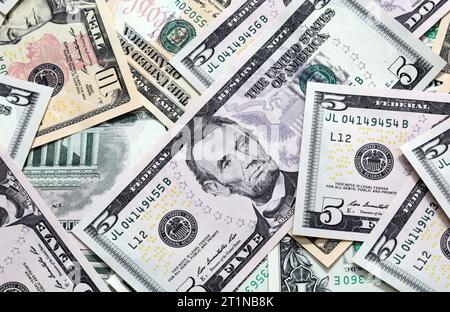 Various US dollar notes scattered. No complete notes shown and angled shot. Focus on central banknote. Stock Photo