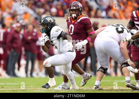 Blacksburg, Virginia, USA. 14th Oct, 2023. Wake Forest Demon Deacons running back Justice Ellison (6) carries the ball during the NCAA football game between the Wake Forest Demon Deacons and the Virginia Tech Hokies at Lane Stadium in Blacksburg, Virginia. Greg Atkins/CSM/Alamy Live News Stock Photo