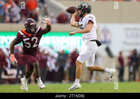 Blacksburg, Virginia, USA. 14th Oct, 2023. Wake Forest Demon Deacons quarterback Michael Kern (15) makes a crossbody throw during the NCAA football game between the Wake Forest Demon Deacons and the Virginia Tech Hokies at Lane Stadium in Blacksburg, Virginia. Greg Atkins/CSM/Alamy Live News Stock Photo