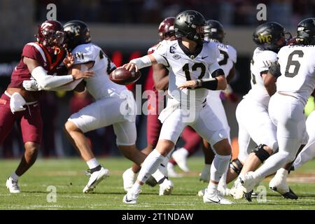 Blacksburg, Virginia, USA. 14th Oct, 2023. Wake Forest Demon Deacons quarterback Mitch Griffis (12) passes the ball during the NCAA football game between the Wake Forest Demon Deacons and the Virginia Tech Hokies at Lane Stadium in Blacksburg, Virginia. Greg Atkins/CSM/Alamy Live News Stock Photo