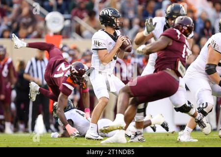 Blacksburg, Virginia, USA. 14th Oct, 2023. Wake Forest Demon Deacons quarterback Michael Kern (15) stands in the pocket during the NCAA football game between the Wake Forest Demon Deacons and the Virginia Tech Hokies at Lane Stadium in Blacksburg, Virginia. Greg Atkins/CSM/Alamy Live News Stock Photo