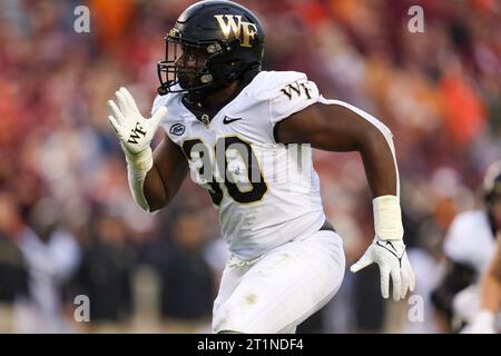 Blacksburg, Virginia, USA. 14th Oct, 2023. Wake Forest Demon Deacons defensive lineman Jasheen Davis (30) rushes the passer during the NCAA football game between the Wake Forest Demon Deacons and the Virginia Tech Hokies at Lane Stadium in Blacksburg, Virginia. Greg Atkins/CSM/Alamy Live News Stock Photo