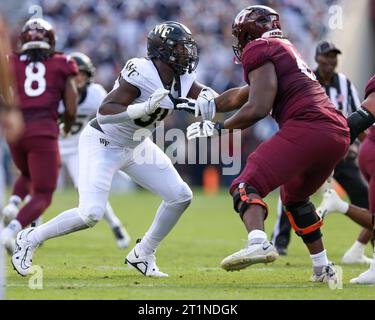 Blacksburg, Virginia, USA. 14th Oct, 2023. Wake Forest Demon Deacons defensive lineman Jasheen Davis (30) rushes the passer during the NCAA football game between the Wake Forest Demon Deacons and the Virginia Tech Hokies at Lane Stadium in Blacksburg, Virginia. Greg Atkins/CSM/Alamy Live News Stock Photo