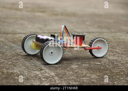 Hand made robot car with a control circuit and a programmable controller. Robotic car working model that is controlled remotely Stock Photo