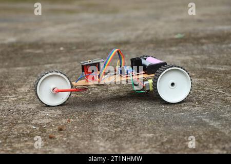 View of a robotic car having 3 wheels. Robot car that is controlled using a programmable micro controller board working prototype Stock Photo