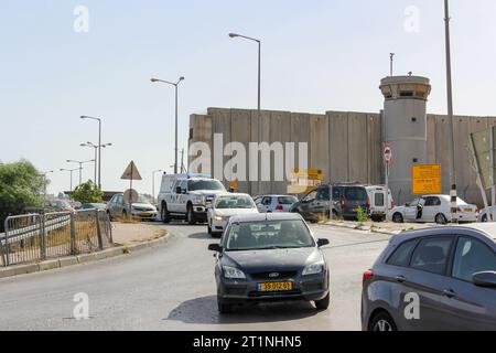 Israeli vehicles pass through the Hizma Checkpoint at the West Bank separation wall north of Jerusalem, Israel. Stock Photo