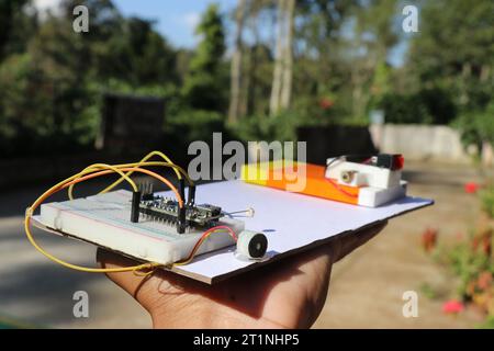 Laser security alarm project made using microcontroller connected to breadboard having the buzzer and LDR while other circuit has a LED module Stock Photo