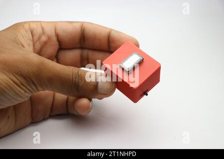 Small Bluetooth speaker held in the hand. Modern speakers made at home using 3d printed technology Stock Photo
