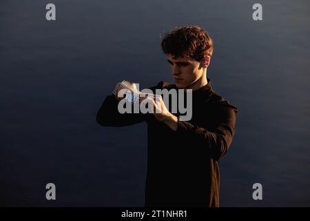 Barber holds in his hands a clipper and a comb Stock Photo