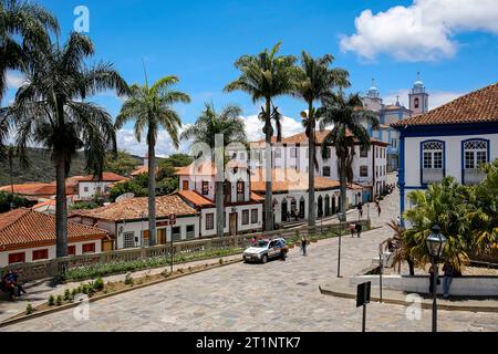 View to traditional houses and palm tree lined street in historic center of Diamantina on a sunny day, Minas Gerais, Brazil Stock Photo