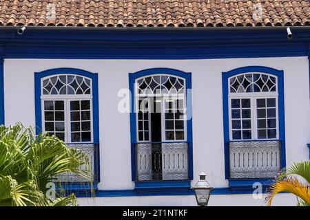 Close-up front view of an historical building with three windows in white and blue, Diamantina, Minas Gerais, Brazil Stock Photo