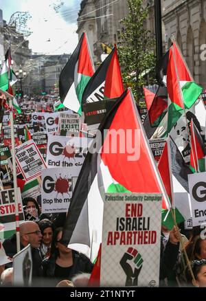 London, UK. 14th Oct, 2023. Protesters carry Palestinian flags and placards demanding an end to the Gaza siege as they wait down Regent Street. Groups came together to march to Downing Street to support the Palestinian people ahead of Israeli reprisals after Hamas's recent attack on Israeli civilians. In an attempt to diffuse raised tensions the Home Secretary has reminded police officers that waving Palestinian flags and using chants and slogans might contravene the Public Order Act. Credit: SOPA Images Limited/Alamy Live News Stock Photo