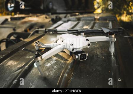 a drone on the tank's armor. The concept of modern military conflicts.. help of reconnaissance drones in modern warfare. Stock Photo