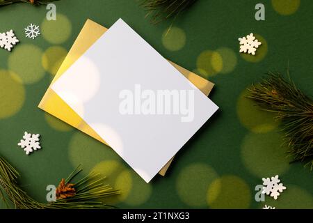 Christmas decorations with white card and copy space on green background Stock Photo