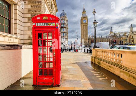 London, England, UK - March 14, 2023: The red telephone booth and Big Ben Clock Tower in the background. Stock Photo