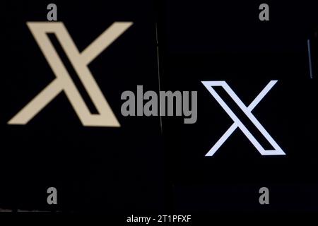 The logo in the form of the letter X displayed on the smartphone. and letter X and website, rebranded Tweeter, on the computer screen Stock Photo