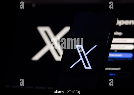 The logo in the form of the letter X displayed on the smartphone. and letter X and website, rebranded Tweeter, on the computer screen Stock Photo