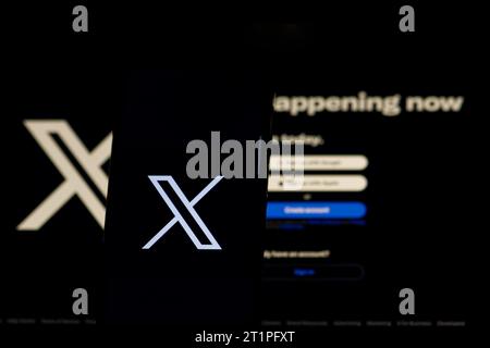 The logo in the form of the letter X displayed on the smartphone. and letter X and website, rebranded Tweeter, on the computer screen Stock Photo