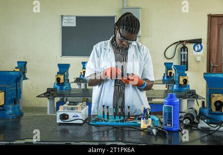 Female technician at the Vocational training centre repairing a mobile phone in Dar es Salaam, Tanzania on October 1, 2021 Stock Photo