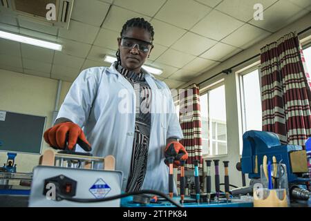 Female technician at the Vocational training centre repairing a mobile phone in Dar es Salaam, Tanzania on October 1, 2021 Stock Photo