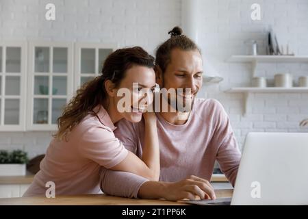 Excited cheerful young family couple getting great good news Stock Photo
