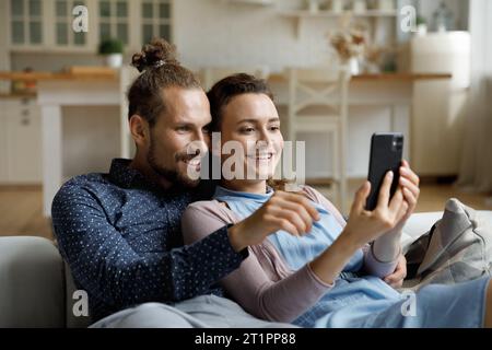 Happy sweet young couple taking selfie picture on mobile phone Stock Photo