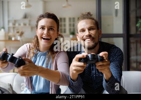 Amazed happy young couple having fun at home Stock Photo