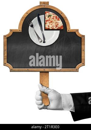 Hand of a chef with white glove holding a template for a pizza menu. Wooden sign with a slice of pizza, empty plate with cutlery and empty blackboard. Stock Photo