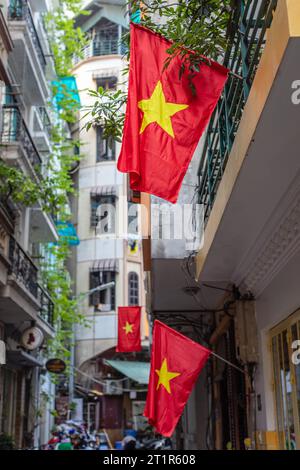 Vietnamese red flags in Old Quarter or Phố cổ Hà Nội, Hanoi, Vietnam. Stock Photo