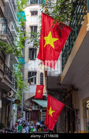 Vietnamese red flags in Old Quarter or Phố cổ Hà Nội, Hanoi, Vietnam. Stock Photo