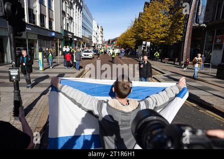 Belfast, UK. 15th Oct, 2023. A few thousand people attend the 'March for Palestine' in the Centre of Belfast to Highlight the Continuing retaliation by the Israel Defence Force in Gaza which has left 2300 death toll to date , after last weekend's massacre of 1300 Israelis by Hamas. There was a small Counter Demonstration by a few individuals who held up the Star of David Flag. The Rally was organised by the Ireland Palestine Solidarity Campaign (IPSC) Credit: Bonzo/Alamy Live News Stock Photo