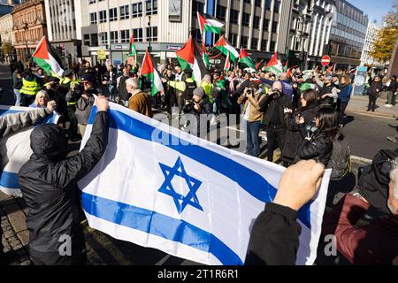 Belfast, UK. 15th Oct, 2023. A few thousand people attend the 'March for Palestine' in the Centre of Belfast to Highlight the Continuing retaliation by the Israel Defence Force in Gaza which has left 2300 death toll to date , after last weekend's massacre of 1300 Israelis by Hamas. There was a small Counter Demonstration by a few individuals who held up the Star of David Flag. The Rally was organised by the Ireland Palestine Solidarity Campaign (IPSC) Credit: Bonzo/Alamy Live News Stock Photo