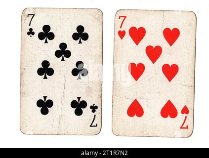 Vintage playing cards featuring a pair of sevens on a white background. Stock Photo