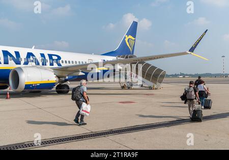 Ferno, Milan-Malpensa, Italy - October 3, 2023: Passengers boarding at low cost airline company Ryanair in the Milan-Malpensa international airport. Stock Photo