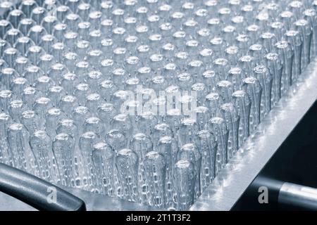 Glass ampoule in production in the tray of an automatic liquid dispenser, a line for filling medicines against bacteria and viruses, antibiotics and v Stock Photo