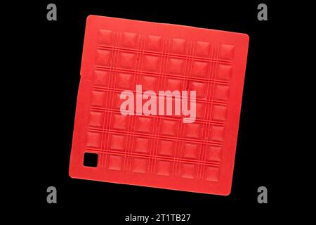 One silicone pot holder, macro, isolated on black background, top view. Stock Photo