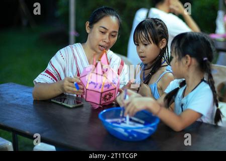 Asian families make wishes and hang lanterns during The Hundred Thousand Lantern Festival or Yi Peng Festival in northern Thailand. Stock Photo