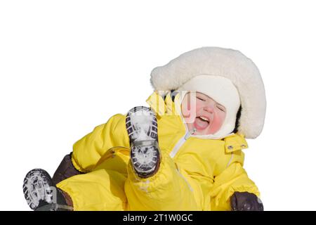 Toddler baby boy rides down a slide playing on a winter playground, isolated on white background. A child in a yellow jumpsuit on a children's slide i Stock Photo