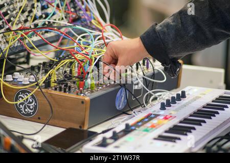 Close-up of the hands of a young man who is working on a DJ console - Moscow, Russia, September 20, 2023 Stock Photo