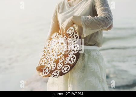 woman moves the hands of a  surreal clock with gears, abstract concept Stock Photo