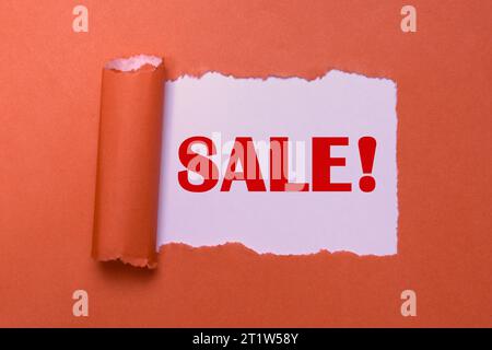 Sale Symbol. Big Discounts and Savings Concept. Red Sale Sign on Torn Paper. Special Offer, Clearance Sale Banner with Copy Space. Stock Photo