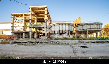 Inside the ruins of an old factory in Romania of a Communist Era. Step inside of abandoned old factory in eastern Europe. Undismantled buildings from Stock Photo