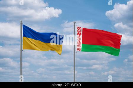 Belarus and Ukraine flags waving together in the wind on blue cloudy sky, two country relationship concept Stock Photo