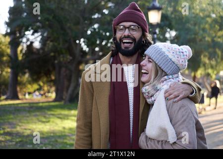 Young couple having fun together outdoors during a walk in a public park. Stock Photo
